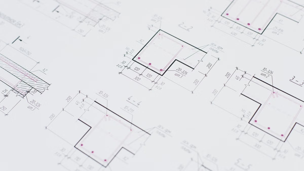 High-resolution close-up of detailed architectural blueprints showcasing precision design layouts.
